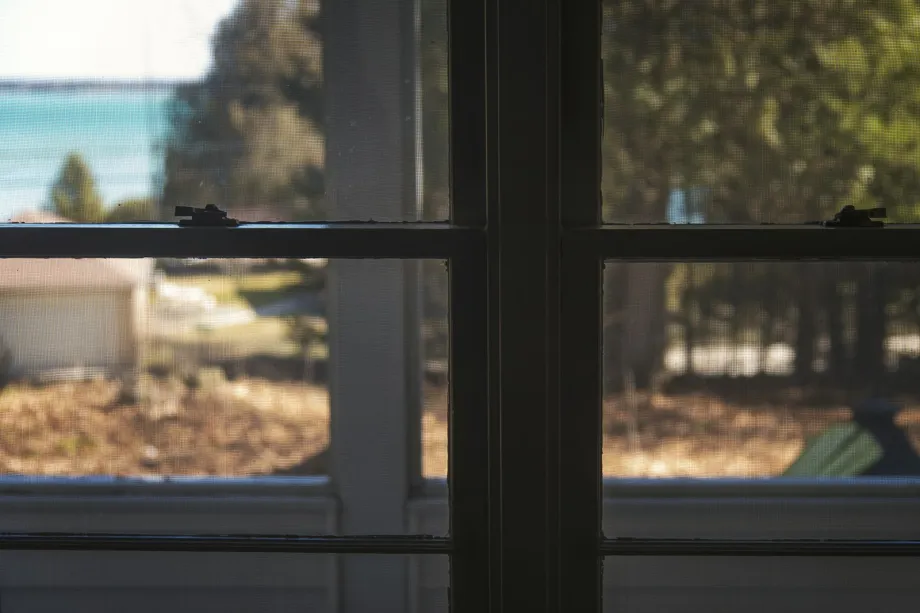 Black-framed glass windows on a front porch